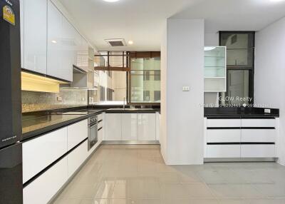 Modern kitchen with white cabinets and black countertops