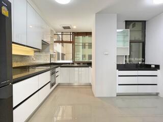 Modern kitchen with white cabinets and black countertops