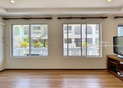 Living room with large windows and sunlight