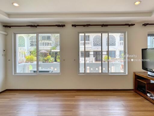 Living room with large windows and sunlight