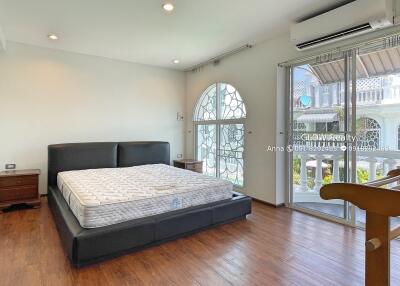 Spacious bedroom with large window and balcony access