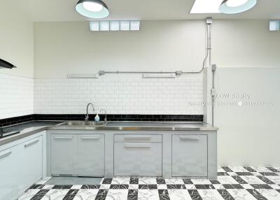 Modern kitchen with stainless steel appliances and checkered floor