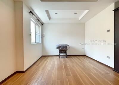 Spacious room with wooden flooring and natural light