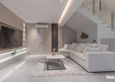 Modern living room with white sofa and marble accents