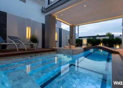 Outdoor pool area with modern design and seating area