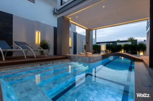 Outdoor pool area with modern design and seating area