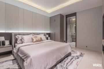 Modern bedroom with a double bed, nightstands, and ensuite bathroom