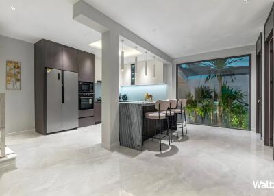 Modern kitchen with island and large glass sliding door