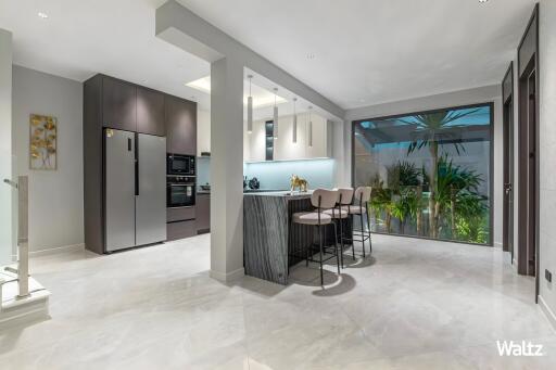 Modern kitchen with island and large glass sliding door