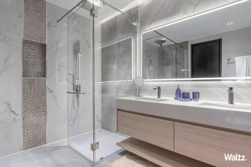 Modern bathroom with glass shower and double sink vanity