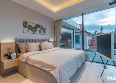 Modern bedroom with large windows and a view