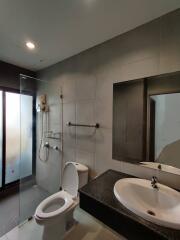 Modern bathroom with a glass shower partition and large mirror