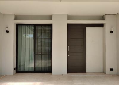 Modern entryway with large window and wooden door