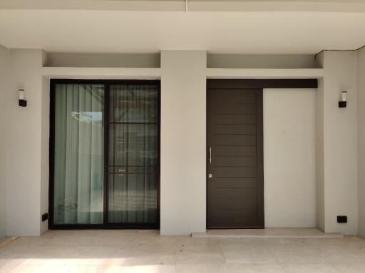 Modern entryway with large window and wooden door