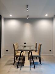 Modern dining room with glass table and upholstered chairs