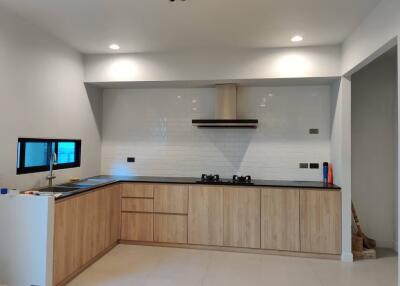 Modern kitchen with wooden cabinets and white tiles