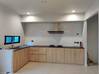 Modern kitchen with wooden cabinets and white tiles