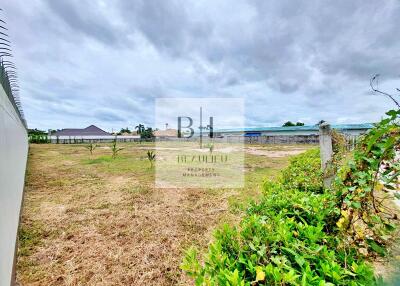 Spacious open lot with clear skies and some vegetation