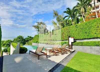 Poolside area with lounge chairs and lush greenery