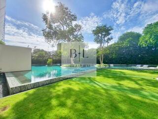 Spacious backyard with pool and greenery