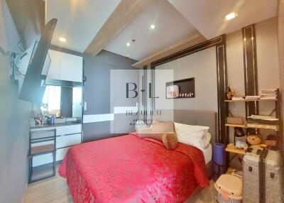 Modern bedroom with red bedding and built-in storage