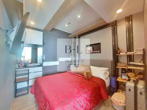 Modern bedroom with red bedding and built-in storage