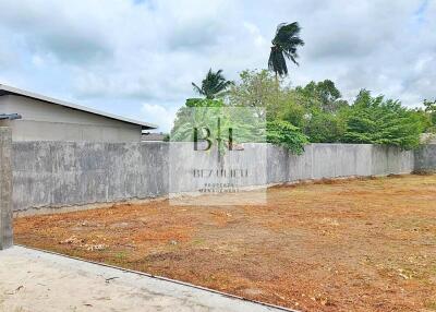 Open yard area with surrounding concrete walls