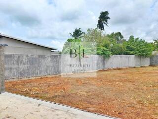 Open yard area with surrounding concrete walls