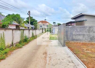 View of a property exterior with surrounding buildings and a driveway