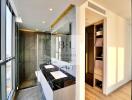 Well-lit modern bathroom with dual sinks and walk-in shower