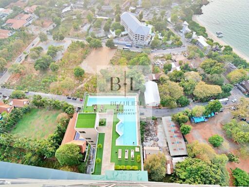 Aerial view of a modern apartment complex with rooftop pool