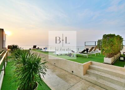 Spacious terrace with lounge chairs and ocean view