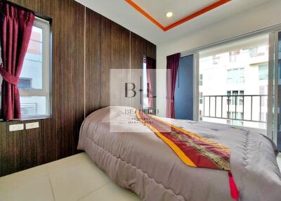 Bedroom with balcony access and vibrant curtains