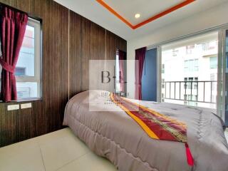 Bedroom with balcony access and vibrant curtains