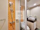 Modern bathroom with orange mosaic tiling and glass shower door