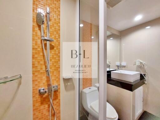 Modern bathroom with orange mosaic tiling and glass shower door