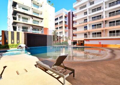 Swimming pool area with buildings in the background