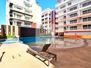 Swimming pool area with buildings in the background