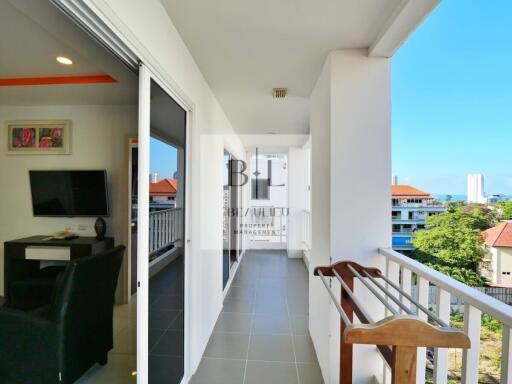 Bright hallway open to balcony with city view