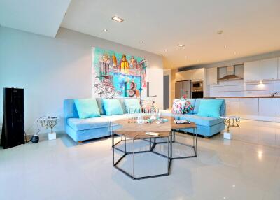 Modern living room with blue sofas and abstract artwork