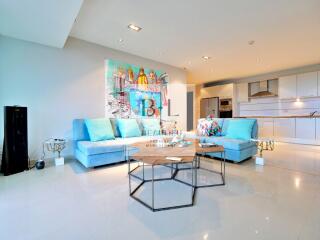 Modern living room with blue sofas and abstract artwork
