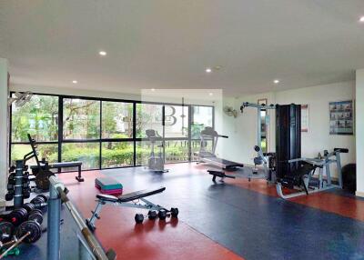 Spacious and well-equipped gym with various exercise machines and weights