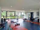 Spacious and well-equipped gym with various exercise machines and weights