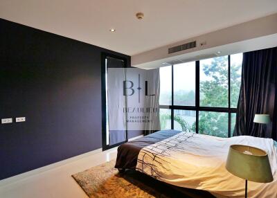 Modern bedroom with large windows and natural light