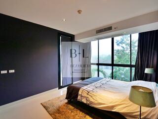 Modern bedroom with large windows and natural light