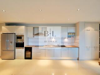 Modern kitchen with white cabinets and built-in appliances