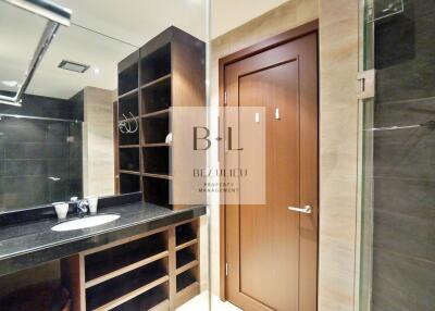 Modern bathroom with wooden storage and glass shower