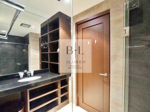 Modern bathroom with wooden storage and glass shower