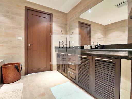 Modern bathroom with double sink and wooden accents