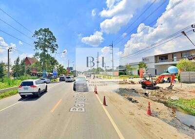 Street view of a developing area with vehicles and construction equipment